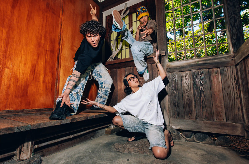Axis Studios Three Person Look - Group of models wearing Distressed Porcelain Jeans, Porcelain Wash Jorts, and embroidered tees in Japanese wooden structure