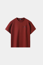 Crimson red oversized T-shirt with small chest logo print, front view on white background.