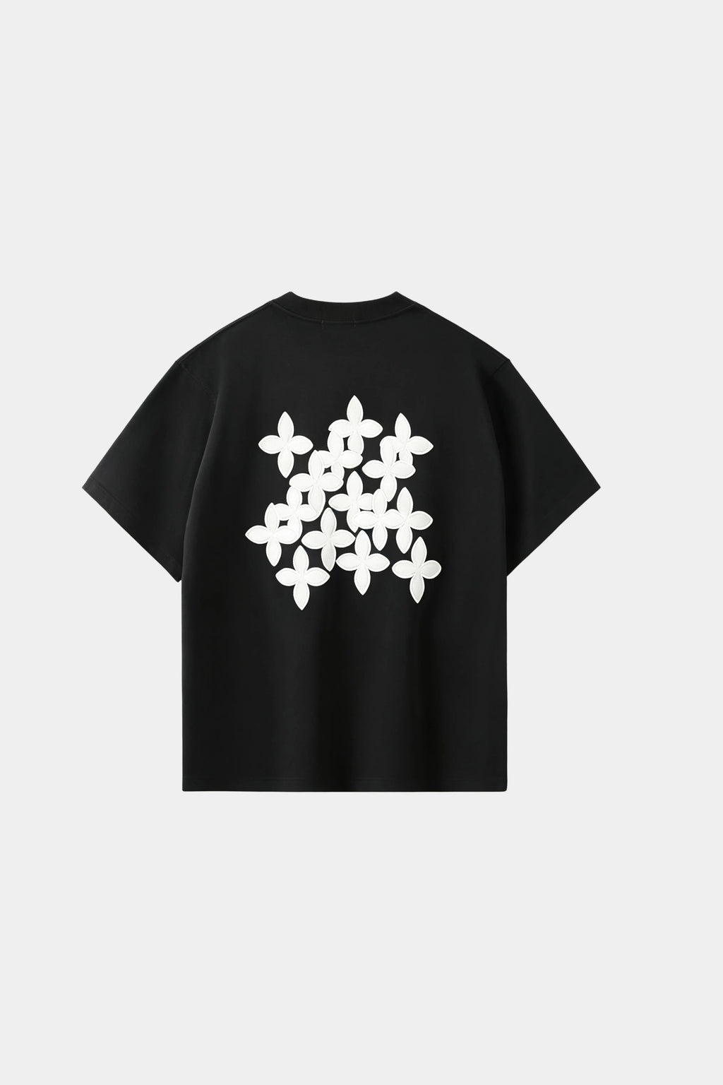 Black oversized T-shirt with black cross-pattern graphic print on chest, front view on white background.