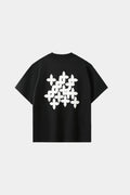 Black oversized T-shirt with black cross-pattern graphic print on chest, front view on white background.