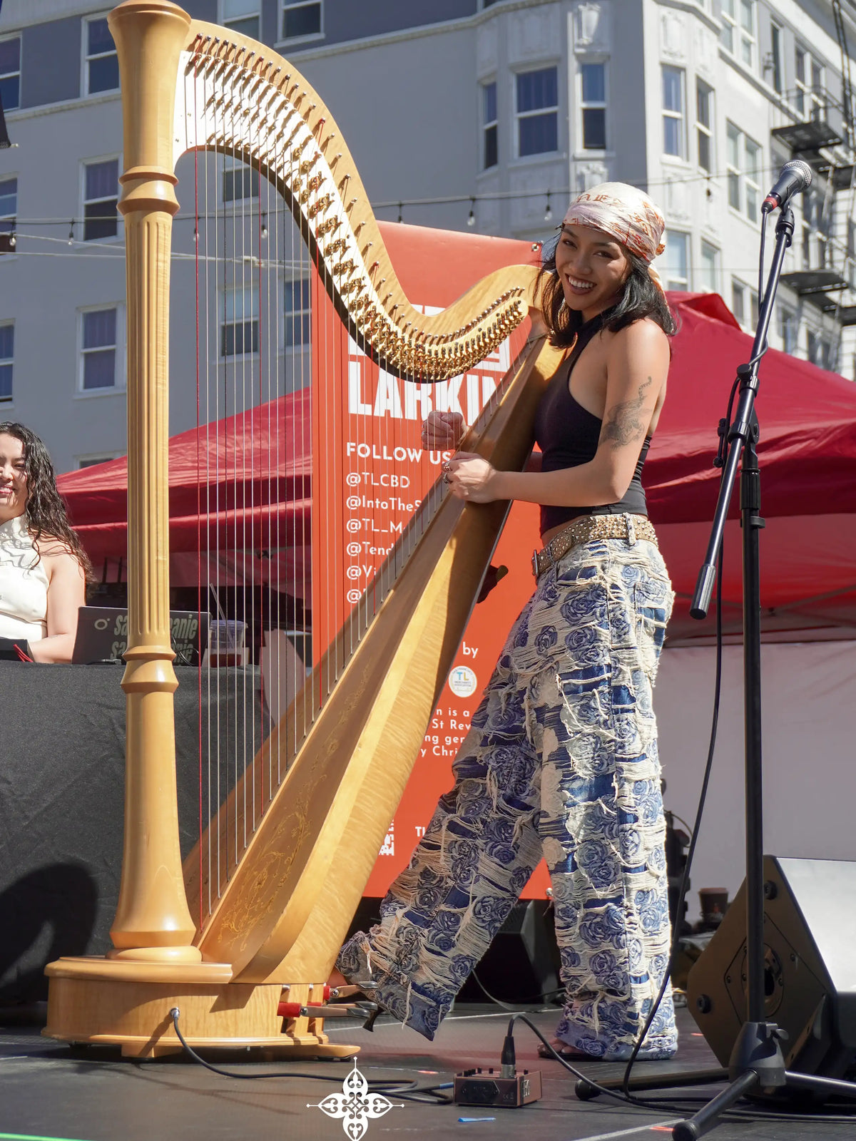 Axis Studios flagship Porcelain Jeans styled on a performing harpist, distressed blue-and-white jacquard denim