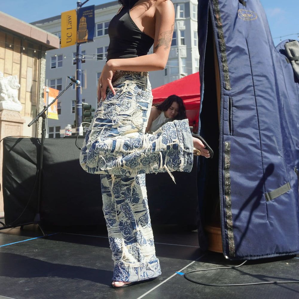 Axis Studios flagship Porcelain Jeans styled on stage, distressed blue-and-white rose jacquard denim