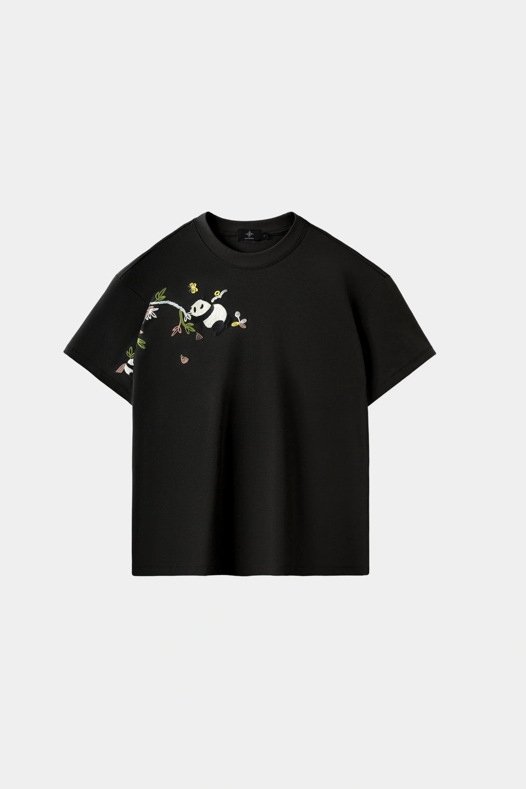 Obsidian black oversized T-shirt with hand-embroidered panda and bamboo branch design across chest and sleeve, front view on white background.