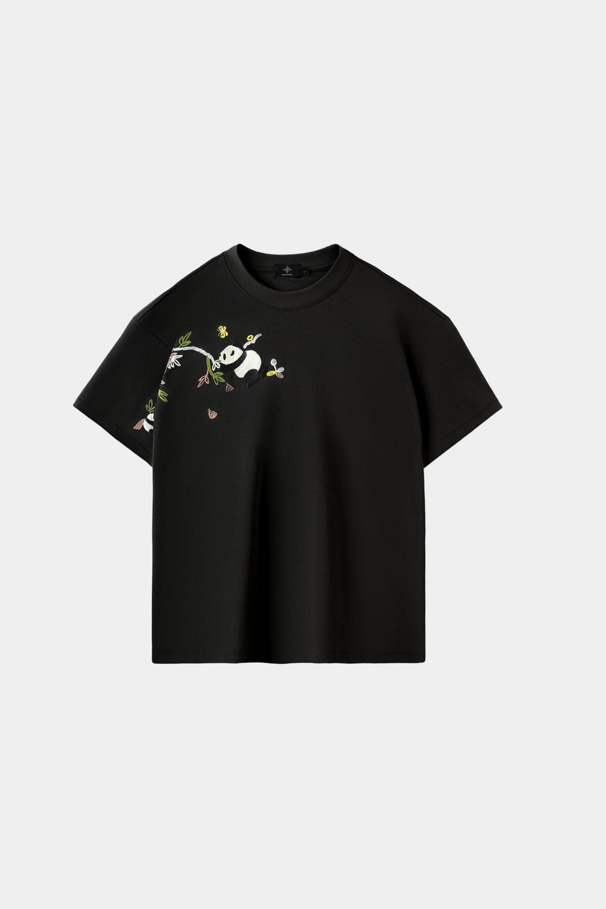 Obsidian black oversized T-shirt with hand-embroidered panda and bamboo branch design across chest and sleeve, front view on white background.