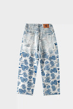 Light blue jeans with a blue and white porcelain rose jacquard pattern and a heavily distressed finish; wide-leg style; reverse side with white background.